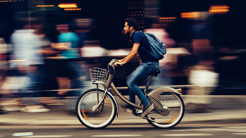 Man cycling through town