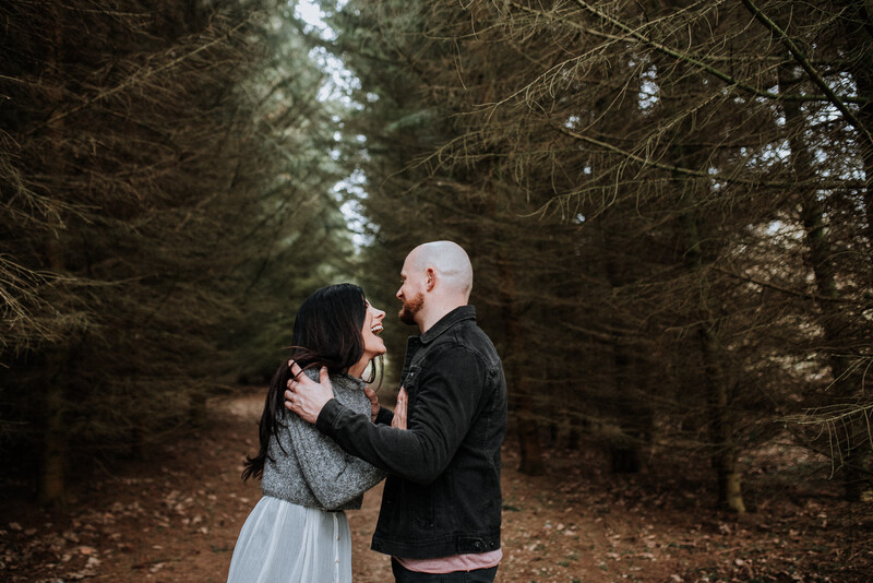 A young couple in a forest.