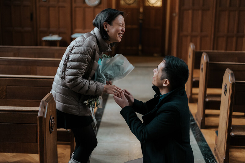 A young woman being proposed to by a man.