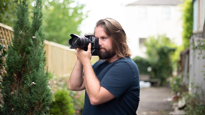 Man photographing with DSLR