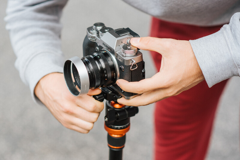 Attaching a Fuji camera to a tripod.