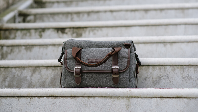 A gray and brown messenger bag on a pair of steps