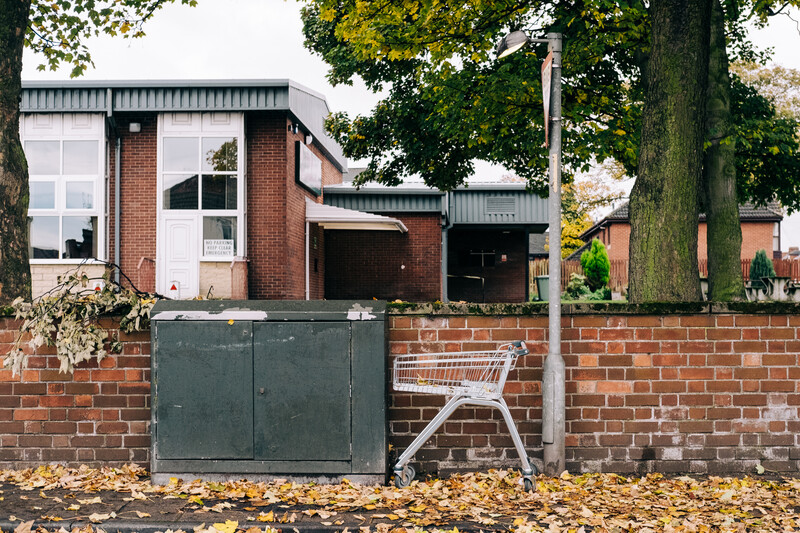 A shopping cart abandoned on a street.