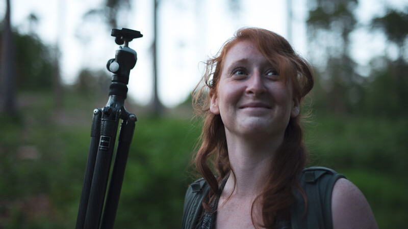 Woman carrying tripod
