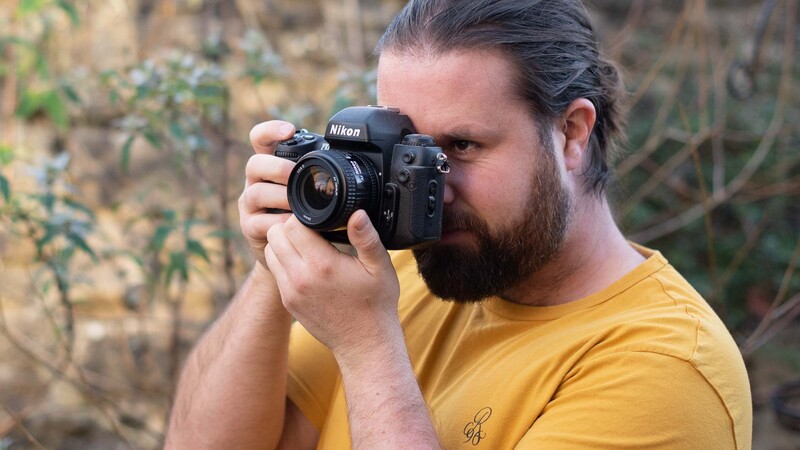 Man with film camera to eye