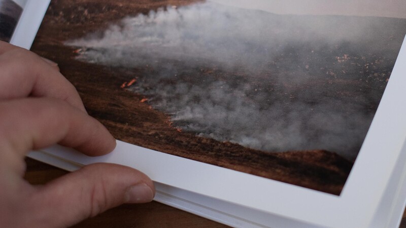 Prints in hand on table