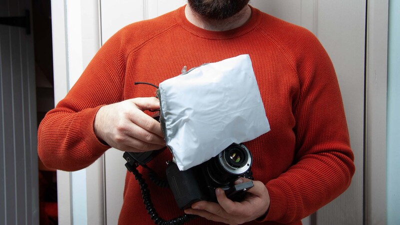 Inflatable soft box diffuser on flash gun