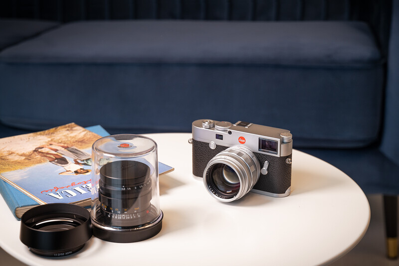 Leica Noctilux-M 50 lens and Leica body on a coffee table.