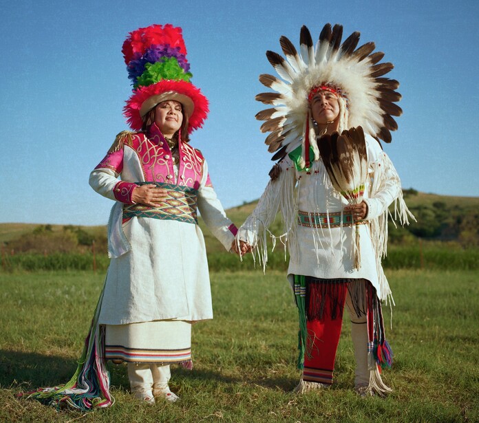 A Native American couple posing outdoors.