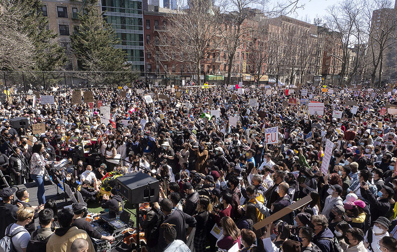 Alice Tsui, a teacher in New York, shares stories of discrimination that she has faced with a packed Columbus Park on Sunday, March 21, 2021 at the AAPI Rally Against Hate. To get this shot, I held my Olympus over my head on a monopod and just poked it ov