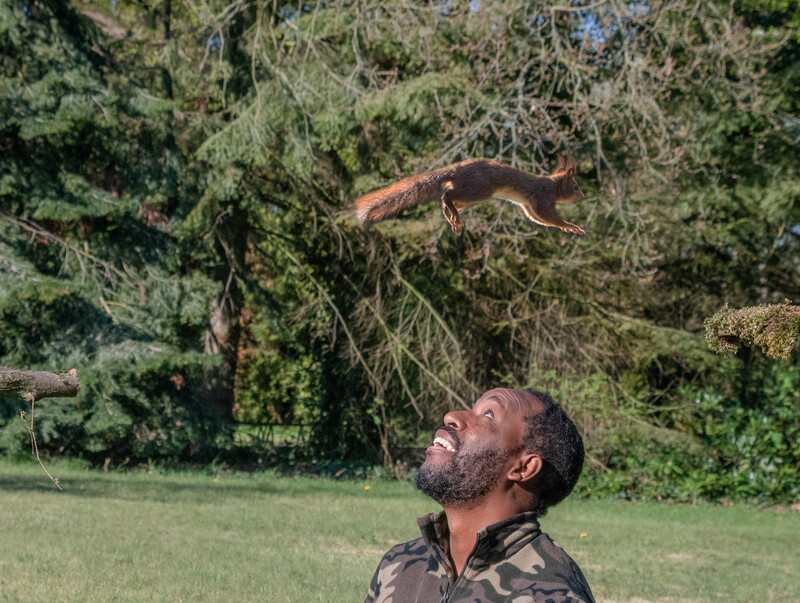 A squirrel jumping over a man