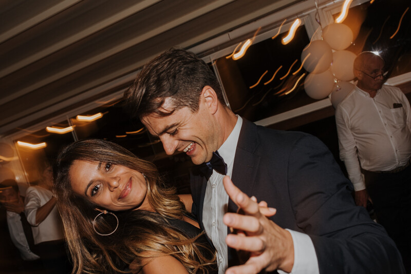 A man dancing with a woman during a wedding.