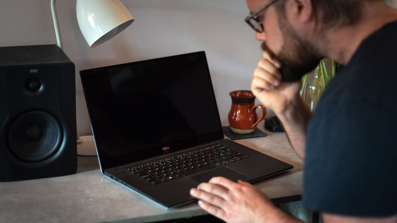 Man on laptop in Lightroom