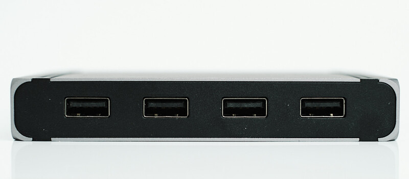 Four-port USB hub with black center panel and silver end caps on white background.