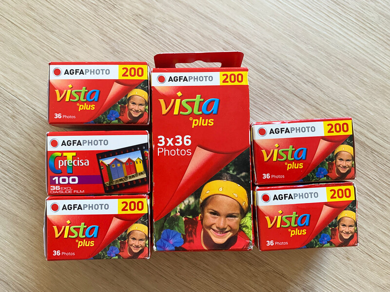 Collection of AGFA Vista Plus 200 film boxes and Fujicolor Precia 100 film box arranged on a wooden surface.