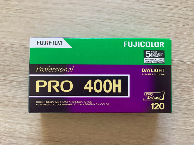 Fujifilm Fujicolor Professional PRO 400H 120 film box on wooden surface.