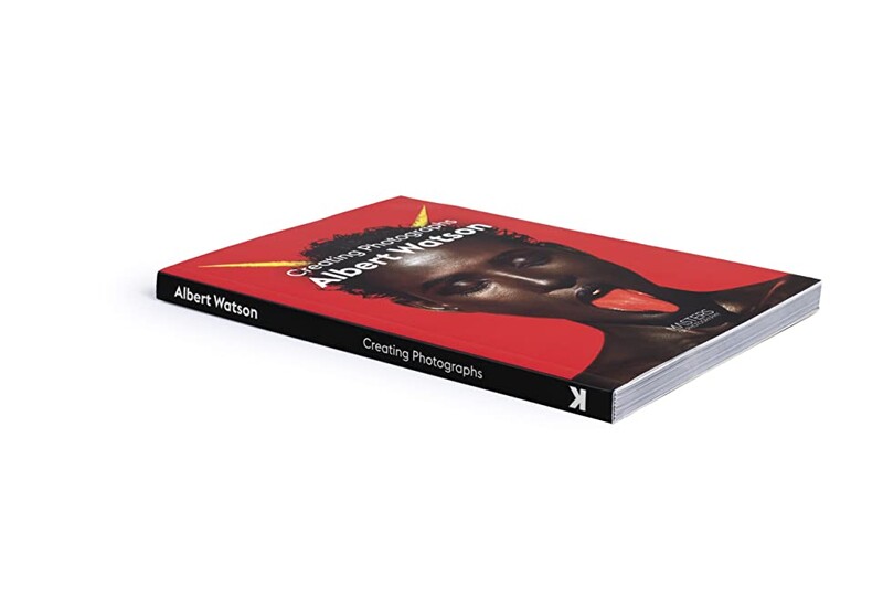 Hardcover book with red and black cover displaying photography techniques and composition principles.