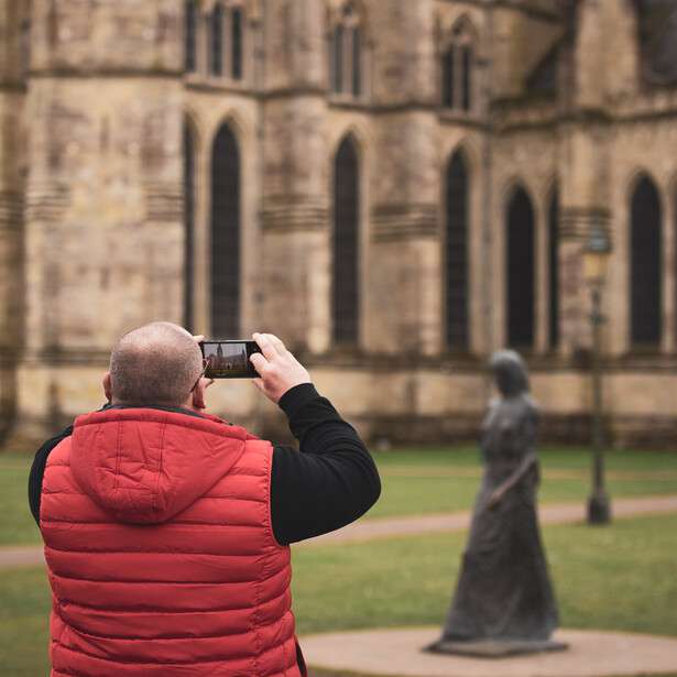 Man and smartphone near cathedral