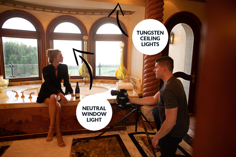 Behind-the-scenes portrait lighting setup with tungsten ceiling lights and neutral window light.