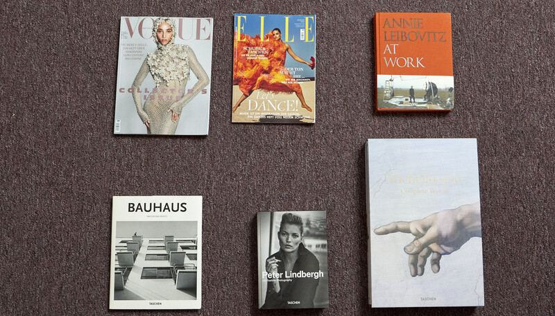 Six design and photography books arranged on a gray textile surface.