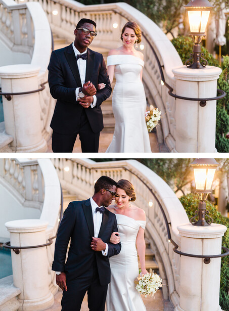 Groom and bride walking together down elegant stone steps at an outdoor wedding venue.