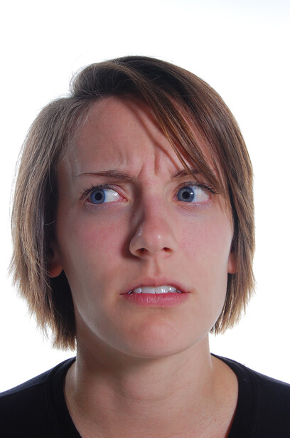 Portrait of a person with shoulder-length brown hair against a white background.