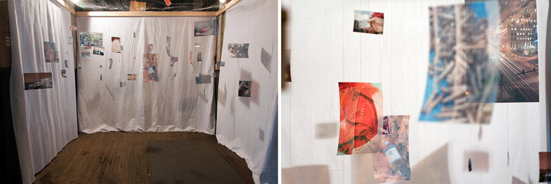 Gallery installation with photographs and prints pinned to white fabric walls in a corner display space.