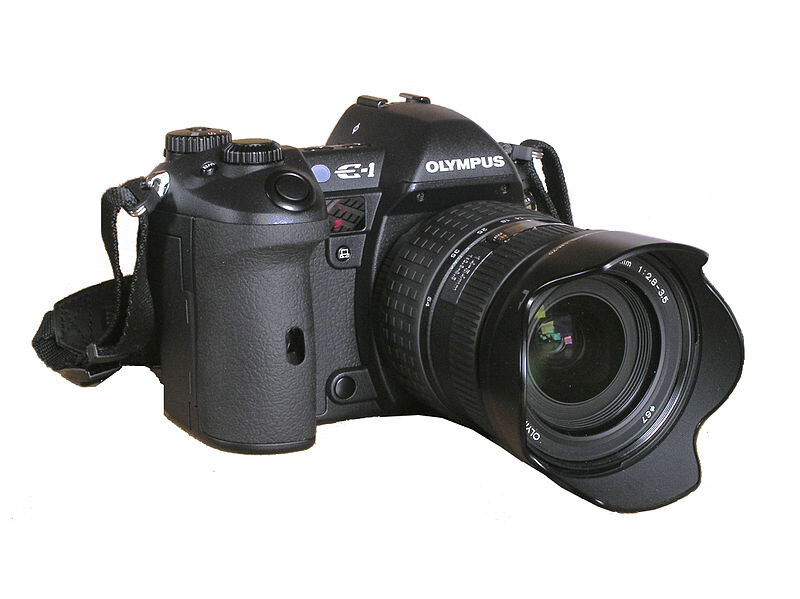 Olympus E-4 DSLR camera with attached wide-angle lens and lens hood on white background.