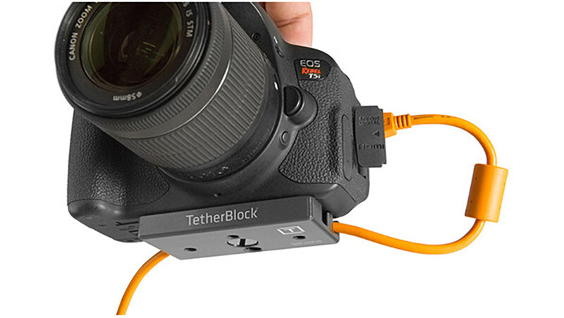 Canon EOS R5 camera with lens mounted on TetherBlock plate with orange tether cable attached.