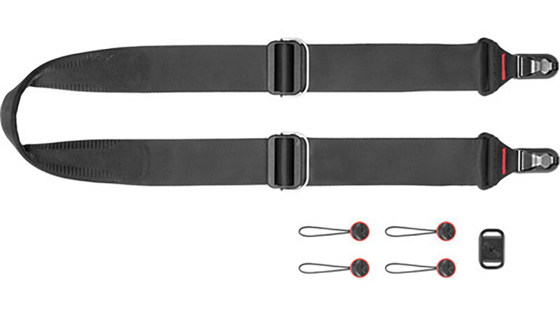 Camera strap with dual attachment points and included accessories kit.