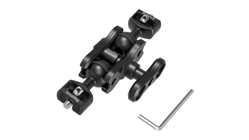 Disassembled camera dolly with wheels, mounting plates, and hex wrench tool laid out separately.