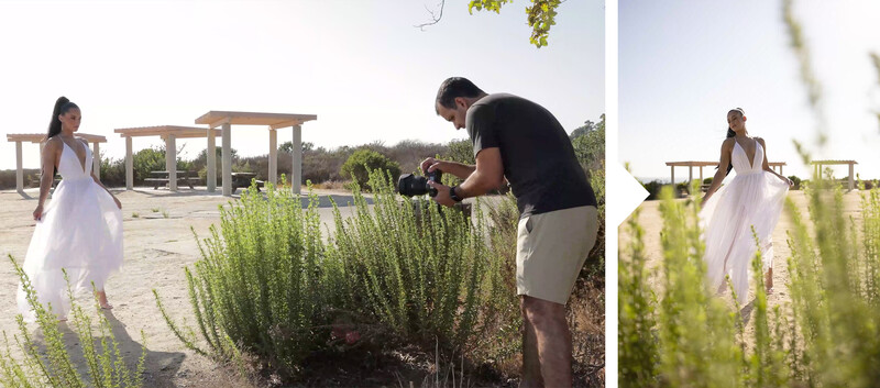 Photographer shooting a bride in a white dress posed among green plants during outdoor portrait session.