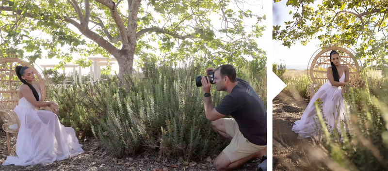 Photographer crouching to compose a portrait of a woman in a white dress posed under a large tree.