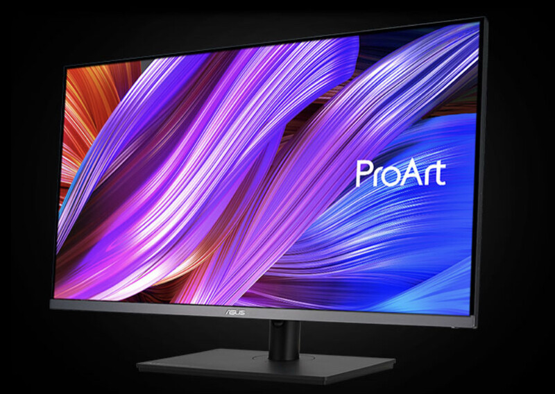 ASUS ProArt monitor displaying abstract flowing blue and purple gradient wallpaper on black stand.