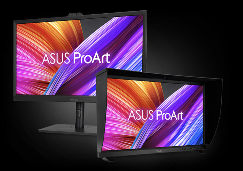 Two ASUS ProArt monitors displaying colorful gradient patterns with purple, orange, and pink stripes.