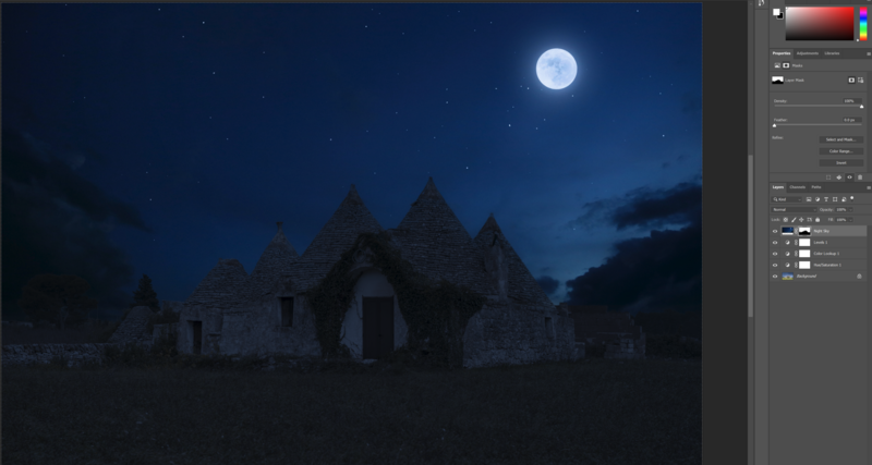 Abandoned stone structure silhouetted against a full moon in a night sky.