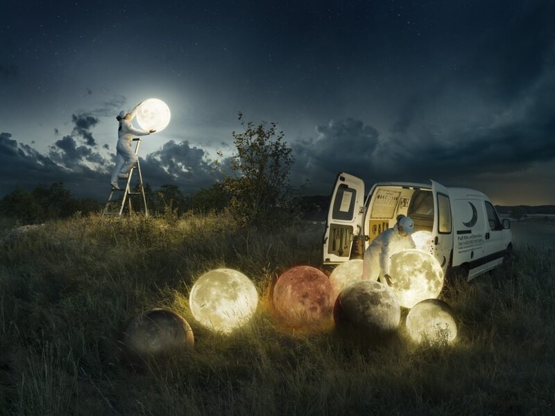 Surreal composite showing a van unloading glowing spheres into a field at night beneath a large moon.