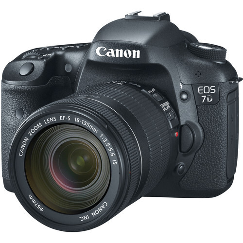 Canon EOS 7D DSLR camera with EF-S 18-135mm kit lens attached, displayed against white background.