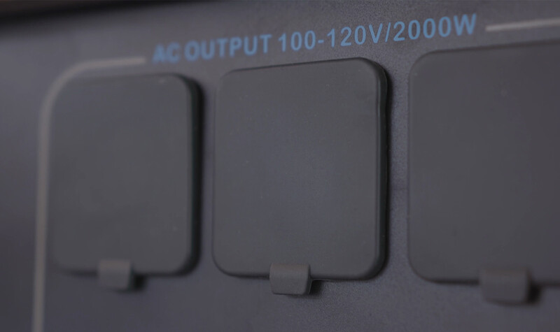 Close-up of three AC outlet sockets on a power device rated 100-120V/2000W.