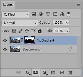 Screenshot of Photoshop Layers panel showing two layers: a selected gradient adjustment layer above a locked background layer with a landscape photo.