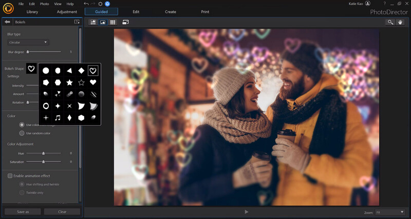 Two people in winter clothing against a blurred colorful background with bokeh lights.