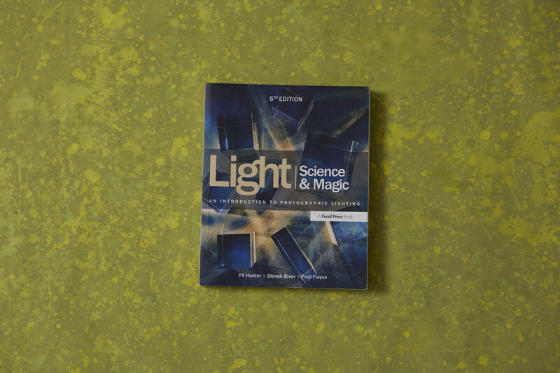Light Science & Magic textbook, 5th edition, displayed on a yellow-green textured surface.