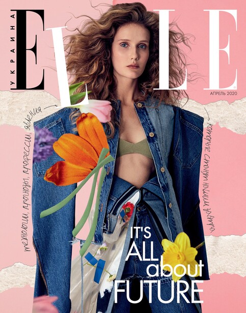 Woman wearing denim jacket and patterned scarf with orange flower against pink background.