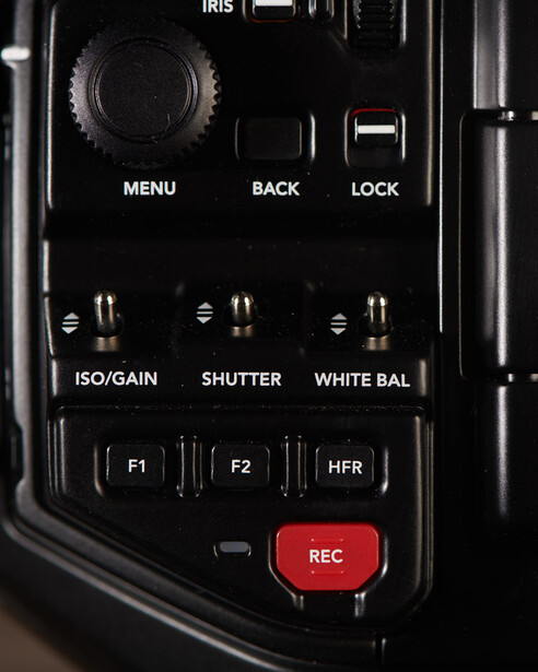 Close-up of camera control panel with buttons for ISO/Gain, Shutter, White Balance, and a red REC button.