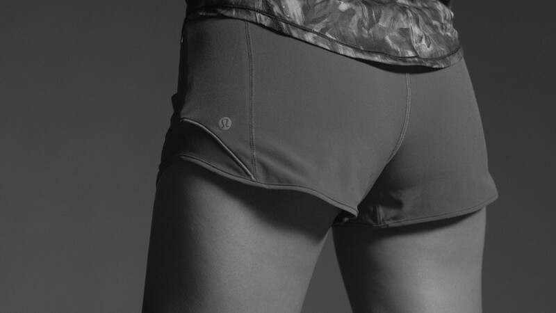 Close-up of male torso wearing gray athletic briefs against neutral background.