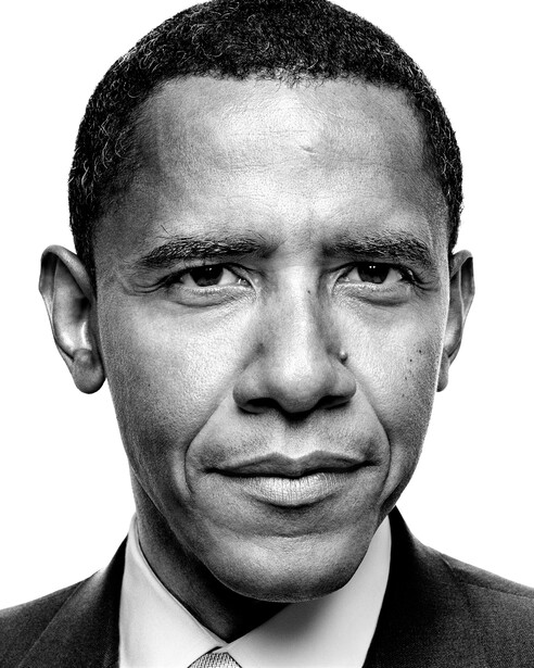 Black and white professional portrait headshot of a man in formal business attire.