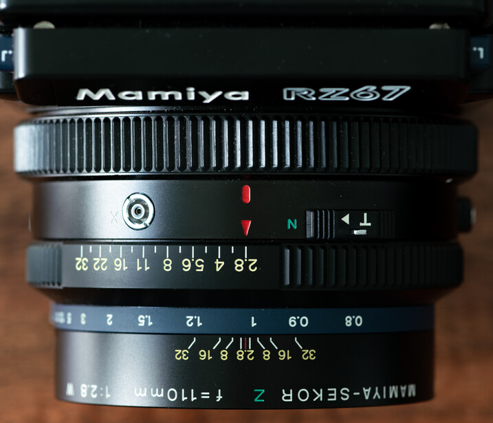 Stacked Mamiya RB267 camera lenses showing focus rings, aperture scales, and focal length markings.