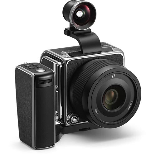 Medium format camera with wide-angle converter lens mounted on top against white background.