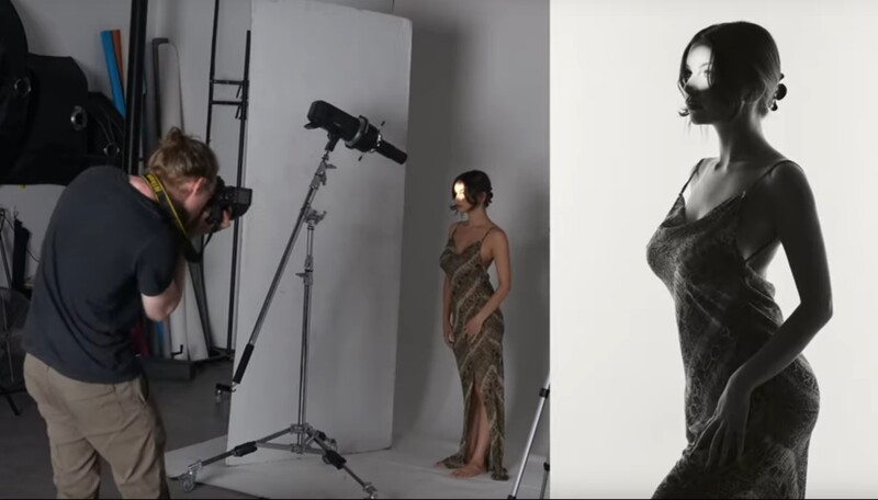 Portrait photographer with camera on tripod capturing model in studio setup with professional lighting.