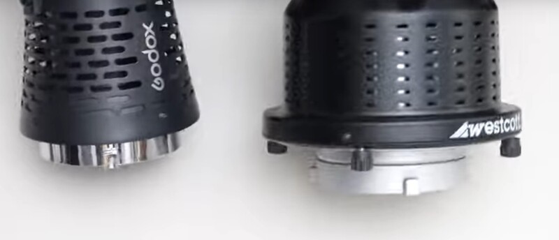 Two studio light modifiers with perforated cylindrical heads and metallic bases side by side.